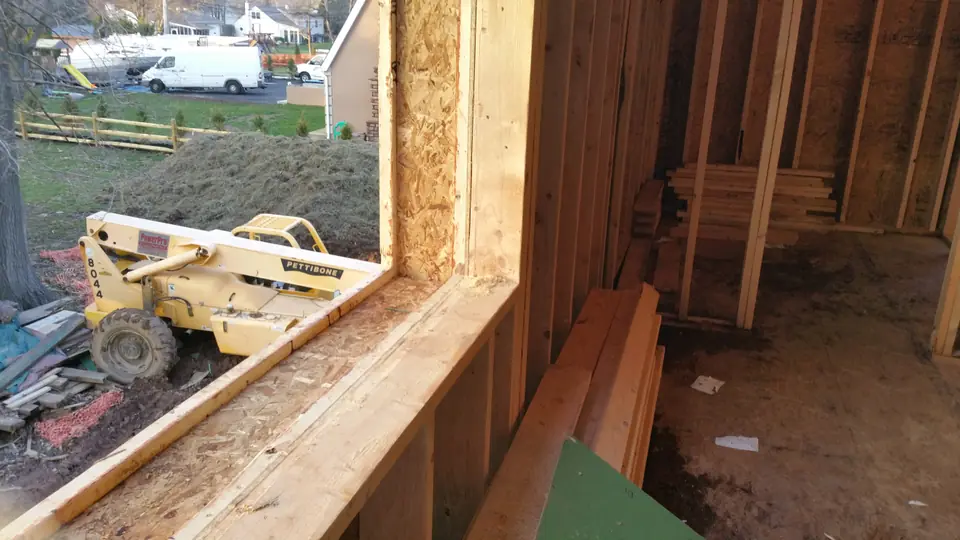 Wall construction detail: 2×6 load-bearing wall on the inside with 9-inch beams hanging on the exterior. These beams later created cavi