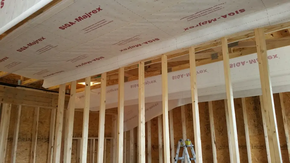 Breathable interior wrap is used to create sealed roof cavities for blown-in cellulose insulation. This is in addition to 5-inch sheets of I