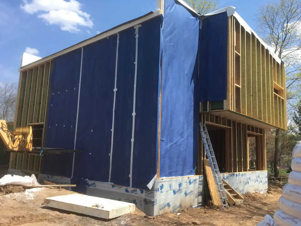 Exterior wrapping has begun. All seams are overlapped by 3 inches and sealed with tape.