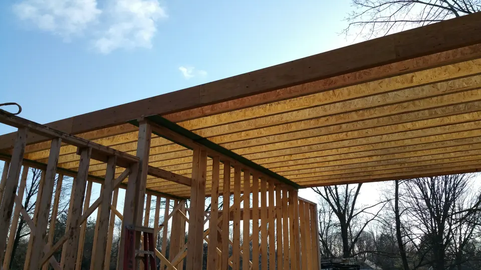 Second-floor beams running across from the main structure over carport and garage to support future master bedroom on top.