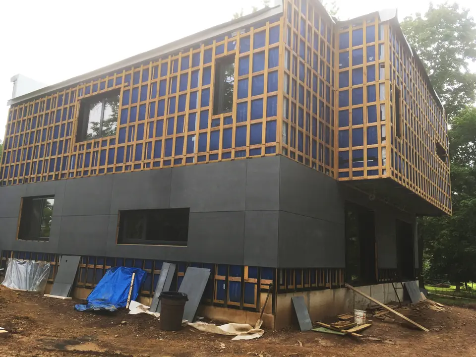 We have decided to install two separate siding materials: large 4×8-foot fiber cement panels and stained fiber cement planks. Both of t